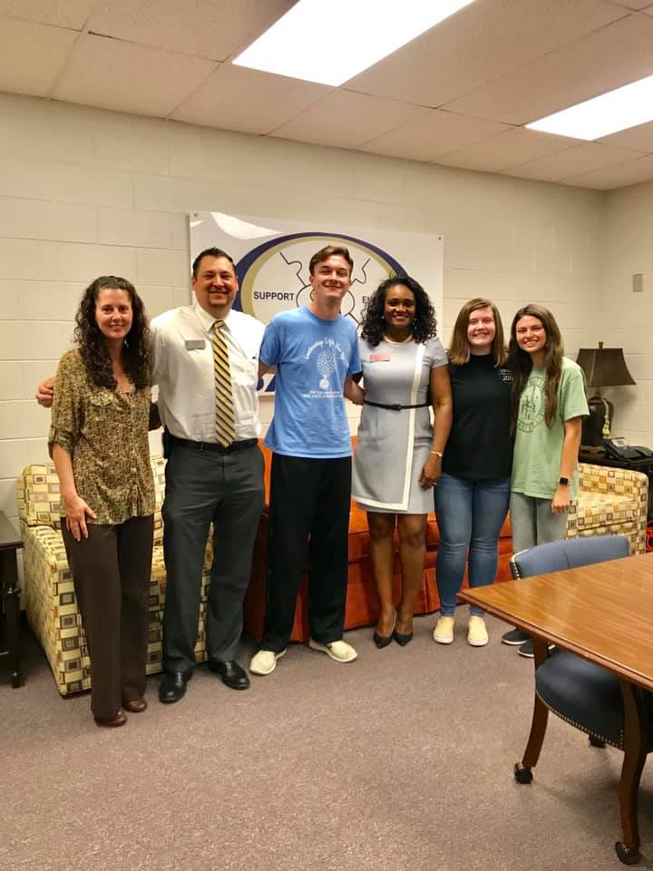 Donna McLeod with students and staff at Dacula High School